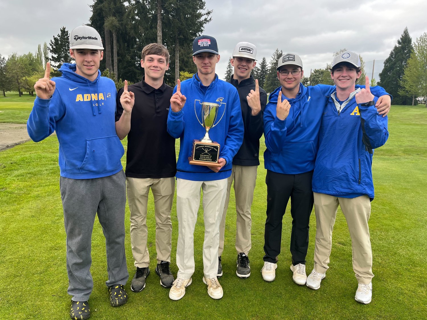 The Adna boys golf team poses with the district championship trophy after winning a team title at the 2B District 4 golf tournament May 18.